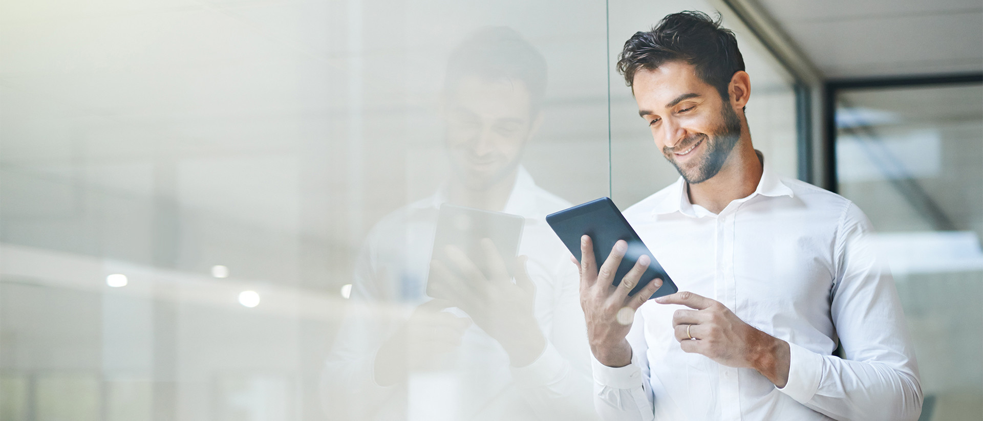 SurePrep Header 1 Man smiling and looking at tablet