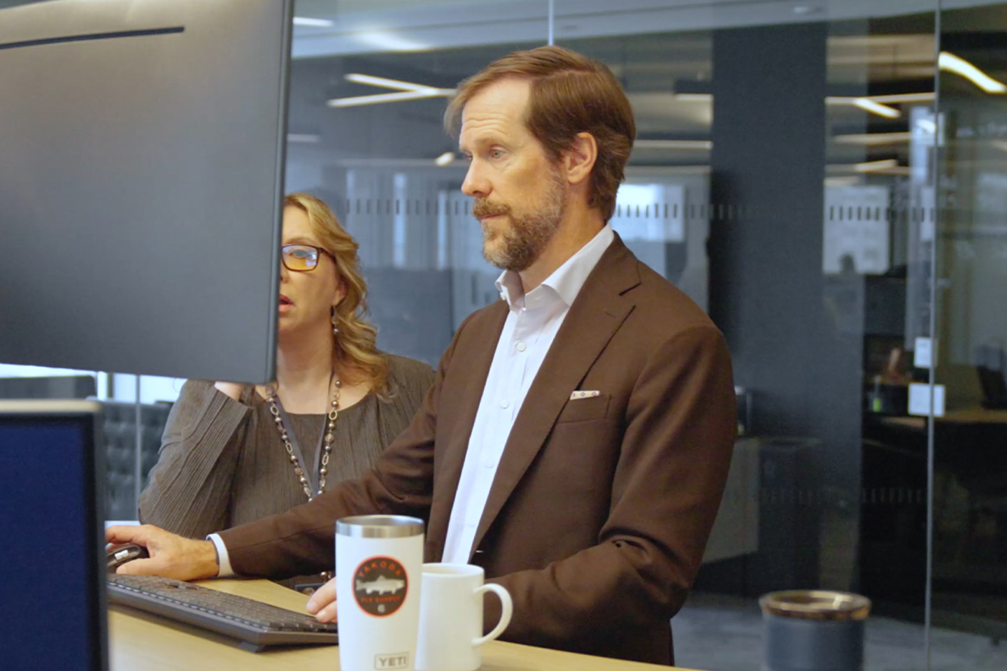 Video still of people working on a computer
